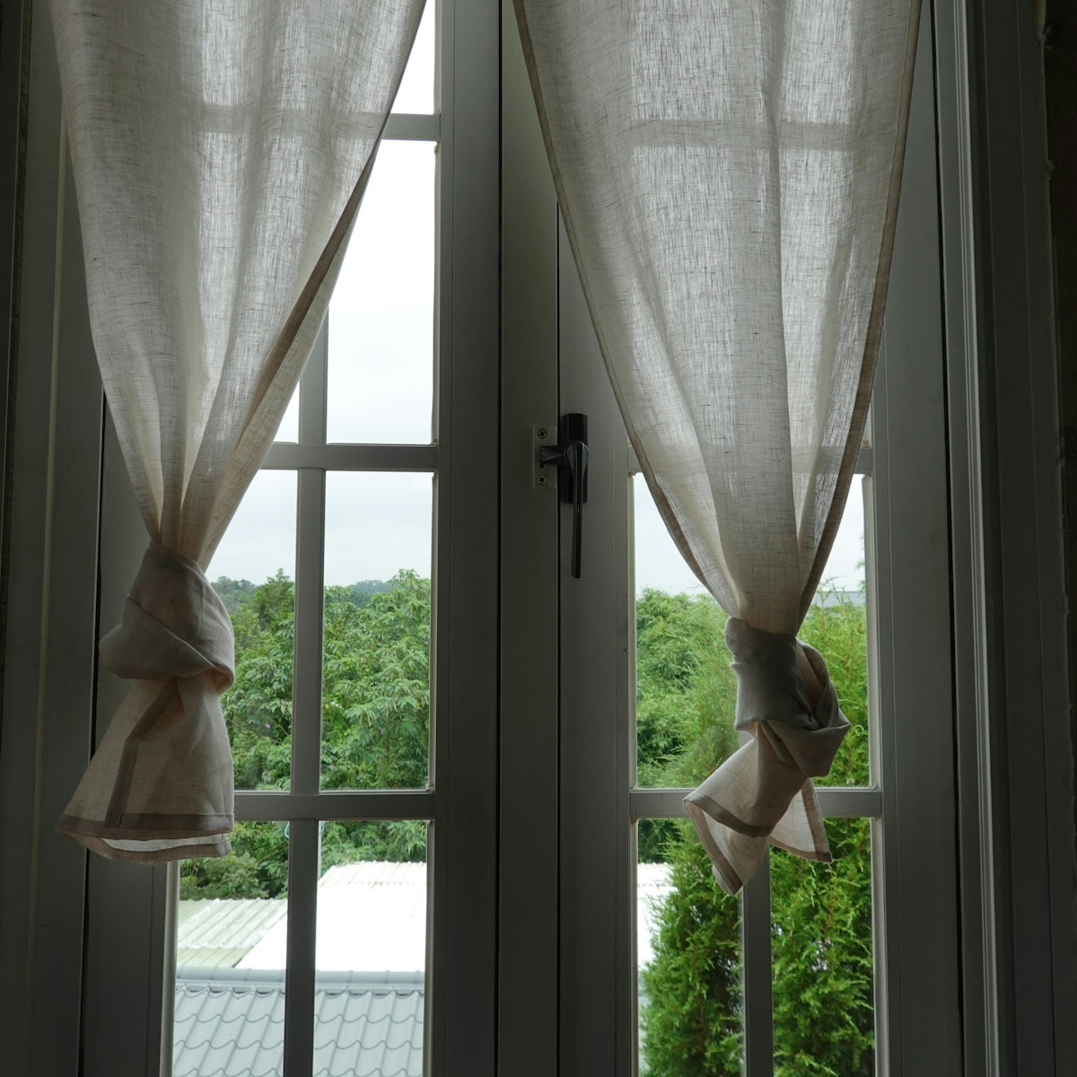 a pair of curtains hanging from the side of a window
